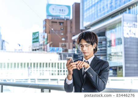 Businessman operating a smartphone Shibuya Businessman operating a smartphone Shibuya 83446276
