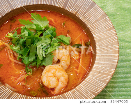 Tom yum kung soup topped with coriander and shrimp. Tom yum kung soup topped with coriander and shrimp. 83447005