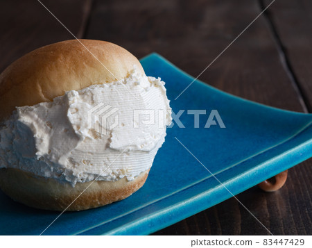 A close-up of Maritozzo with whipped cream sandwiched between breads. A close-up of Maritozzo with whipped cream sandwiched between breads. 83447429
