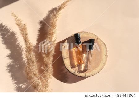 Two glass perfume samples on a wooden tray Stock Photo