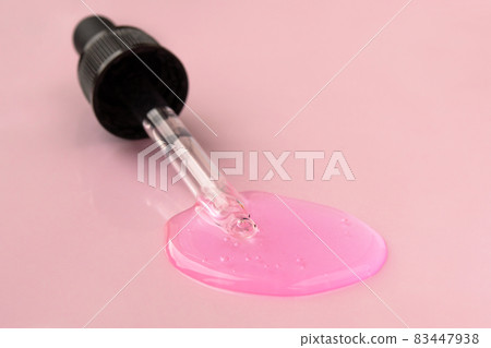 Pipette with fluid hyaluronic acid on pink background. Cosmetics and healthcare concept closeup. Dose of serum or retinol with air bubbles. Flat lay. Luxury gel or beauty product presentation in macro Pipette with fluid hyaluronic acid on pink background. Cosmetics and healthcare concept closeup. Dose of serum or retinol with air bubbles. Flat lay. Luxury gel or beauty product presentation in macro 83447938