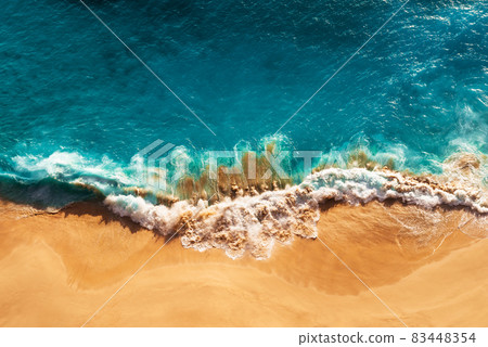 Relaxing aerial beach scene, summer vacation holiday template banner. Waves surf with amazing blue ocean lagoon, sea shore, coastline. Perfect aerial drone top view. Peaceful bright beach, seaside 83448354