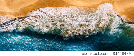Aerial view of blue ocean waves in Kelingking beach, Nusa Penida island in Indonesia. Beautiful sandy beach with blue sea. Lonely sandy beach with beautiful waves. Beaches of Indonesia. Copy space Aerial view of blue ocean waves in Kelingking beach, Nusa Penida island in Indonesia. Beautiful sandy beach with blue sea. Lonely sandy beach with beautiful waves. Beaches of Indonesia. Copy space 83448489