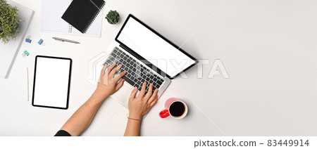 Overhead view man using computer laptop on white background. Overhead view man using computer laptop on white background. 83449914