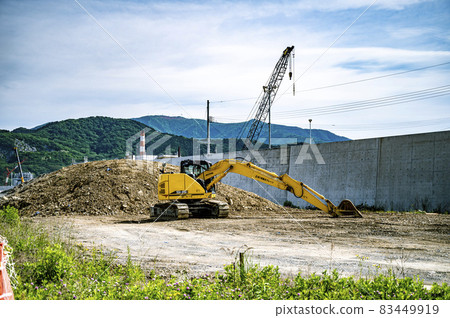 Excavator car resting next to the new seawall 83449919
