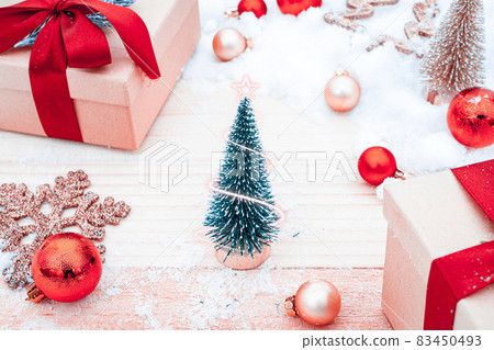 Table wood Christmas. Xmas board with old rustic wall, white frozen snow, golden balls and gift box. Winter wooden decoration background. Happy new year copy space. 83450493