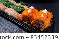Japanese food called sushi . Rice rolls mixed with shrimp, salmon, and seaweed, food bar on black background 83452339