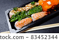 Japanese food called sushi . Rice rolls mixed with shrimp, salmon, and seaweed, food bar on black background 83452344