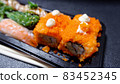 Japanese food called sushi . Rice rolls mixed with shrimp, salmon, and seaweed, food bar on black background 83452345