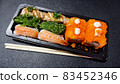 Japanese food called sushi . Rice rolls mixed with shrimp, salmon, and seaweed, food bar on black background 83452346