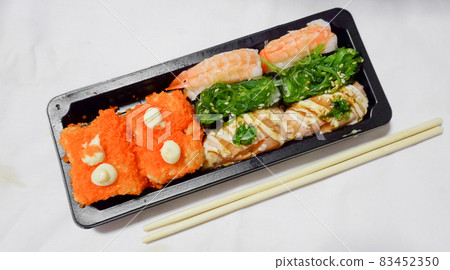 Japanese food called sushi . Rice rolls mixed with shrimp, salmon, and seaweed, food bar on white background. 83452350