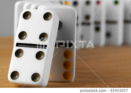 White domino dice on a wooden table 83453057