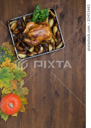 Thanksgiving day with delicious grilled chicken on the background of autumn leaves and harvest pumpkin. 83453465
