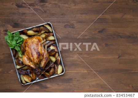 Grilled chicken close-up on a wooden table, top view 83453467