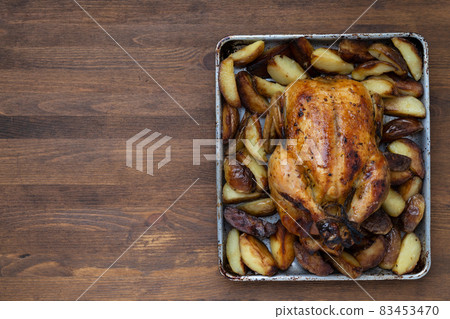 Grilled chicken close-up on a wooden table, top view 83453470