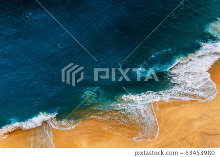Aerial top view from drone of sandy beach with blue sea waves with copy space for text. Summer sea beach top view. Panoramic view of the sea with sandy beach. Seascape, can be used as a background Aerial top view from drone of sandy beach with blue sea waves with copy space for text. Summer sea beach top view. Panoramic view of the sea with sandy beach. Seascape, can be used as a background 83453980