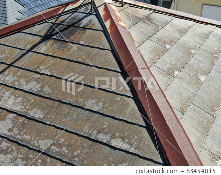 Pre-construction inspection photo taken by drone of the roof deterioration situation before painting the colonial roof of a detached house Pre-construction inspection photo taken by drone of the roof deterioration situation before painting the colonial roof of a detached house 83454015