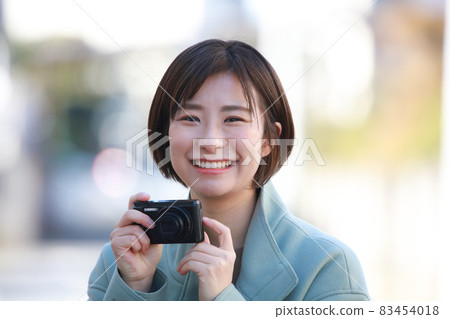 A woman taking a picture A woman taking a picture 83454018