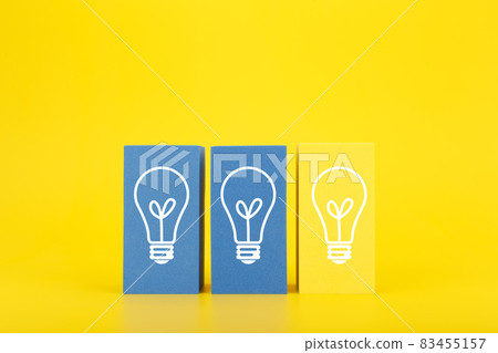 Creativity, brainstorming, innovation and fresh idea concept. Light bulbs on blue and yellow rectangles against yellow background 83455157