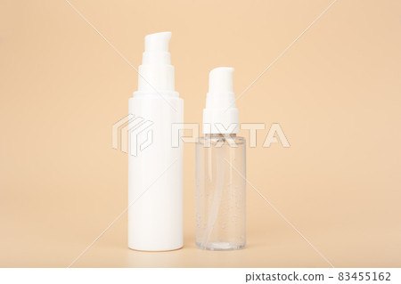Transparent bottle with liquid face gel or foam and skin cream or lotion against bright beige background with copy space Transparent bottle with liquid face gel or foam and skin cream or lotion against bright beige background with copy space 83455162