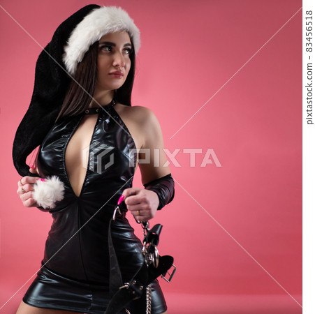 sexy girl in a black Santa hat in a latex... - Stock Photo [83456518] -  PIXTA