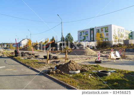 The site of civil engineering works in city is fenced with a tape The site of civil engineering works in city is fenced with a tape 83456825