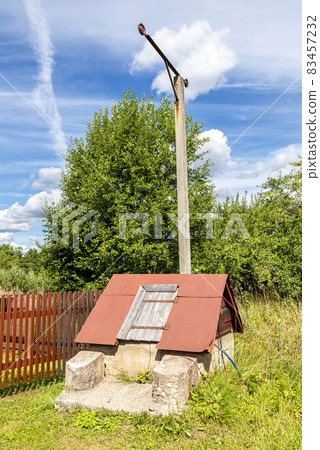 Wooden water well at the countryside in summer Wooden water well at the countryside in summer 83457232