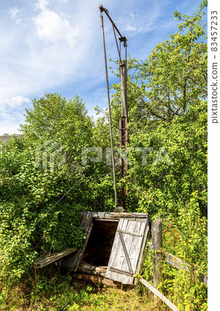 Wooden water well at the countryside in summer Wooden water well at the countryside in summer 83457233