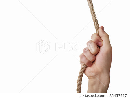 Teenager's hand holding a rope isolated on white background Teenager's hand holding a rope isolated on white background 83457517