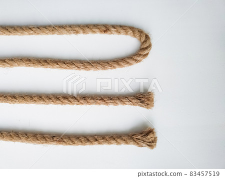 Rough natural rope strings on white background Rough natural rope strings on white background 83457519