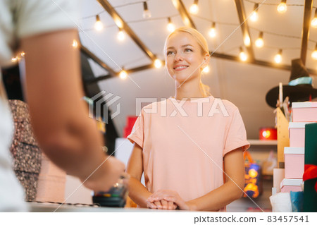 Close-up low-angle view of man paying with NFC technology using smart phone credit card application on POS-terminal, selective focus. Close-up low-angle view of man paying with NFC technology using smart phone credit card application on POS-terminal, selective focus. 83457541