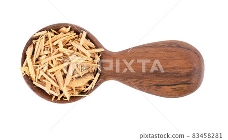 Muira Puama herbal tea in wooden spoon, isolated on white background. Natural potency wood, medicinal plant, dry tea. Ptychopetalum olacoides. Top view. 83458281