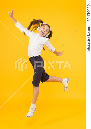 Dancing class. Small dancer moving to music on yellow  83459060
