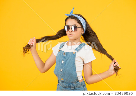 Strong hair. Girl long curly hair sunglasses tied head scarf 83459080