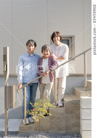 Portrait of grandma, son and three grandchildren in front of a new house 83459908