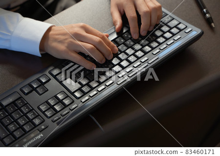 At the hands of a businessman hitting the keyboard 83460171