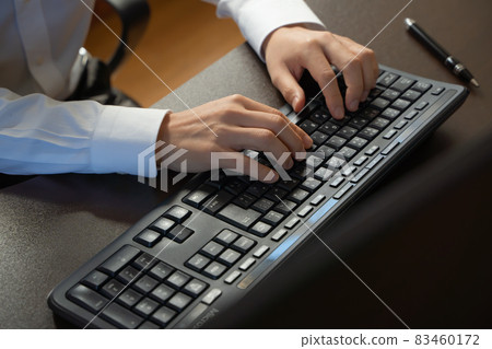 At the hands of a businessman hitting the keyboard At the hands of a businessman hitting the keyboard 83460172