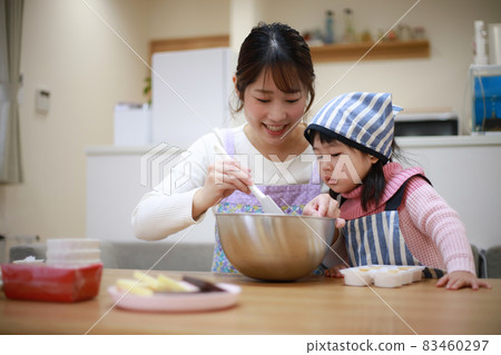 Parents and children making sweets 83460297