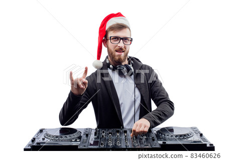 Funny dj guy in Santa's hat, glasses plays music on a turntable while gesturing rock sign 83460626