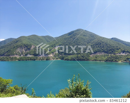 Goluble lake in the daytime and mountains behind it Goluble lake in the daytime and mountains behind it 83461212