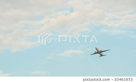 Passenger airplane takes off against the blue sky with clouds. 83461653