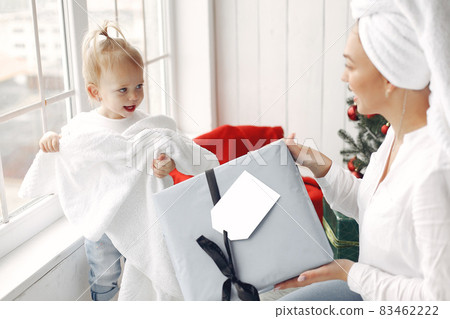 Mother and little daughter spend time with towels on their heads. Mother and little daughter spend time with towels on their heads. 83462222