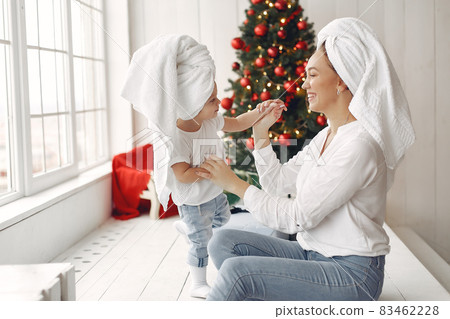 Mother and little daughter spend time with towels on their heads. Mother and little daughter spend time with towels on their heads. 83462228