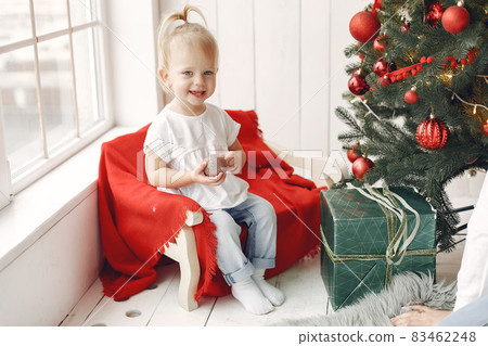 Little girl spends time in the holiday room and playing with toys. Little girl spends time in the holiday room and playing with toys. 83462248