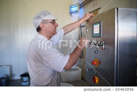 Cheese production cheesemaker working in factory 83463056
