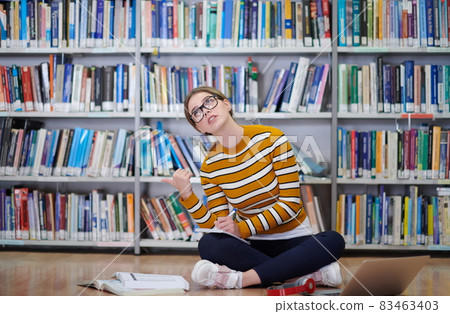 the student uses a notebook and a school library the student uses a notebook and a school library 83463403