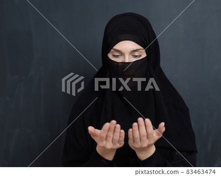 Portrait of young Muslim woman with niqab making dua Portrait of young Muslim woman with niqab making dua 83463474