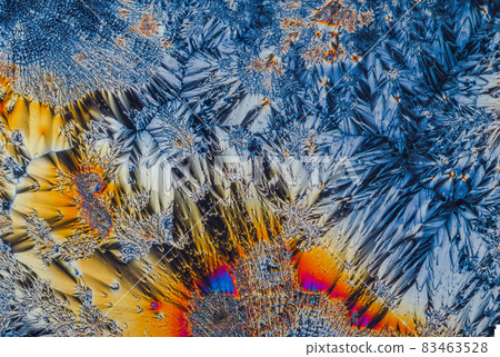 Extreme macro photograph of Vitamin C crystals forming abstract modern art patterns, when illuminated with polarized light, under a microscope objective with 10x magnification Extreme macro photograph of Vitamin C crystals forming abstract modern art patterns, when illuminated with polarized light, under a microscope objective with 10x magnification 83463528