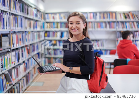 the student uses a notebook and a school library the student uses a notebook and a school library 83463736