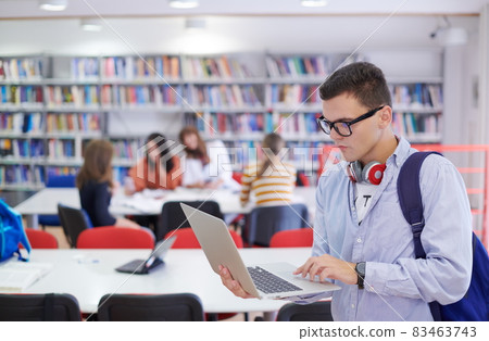 the student uses a notebook, latop and a school library the student uses a notebook, latop and a school library 83463743